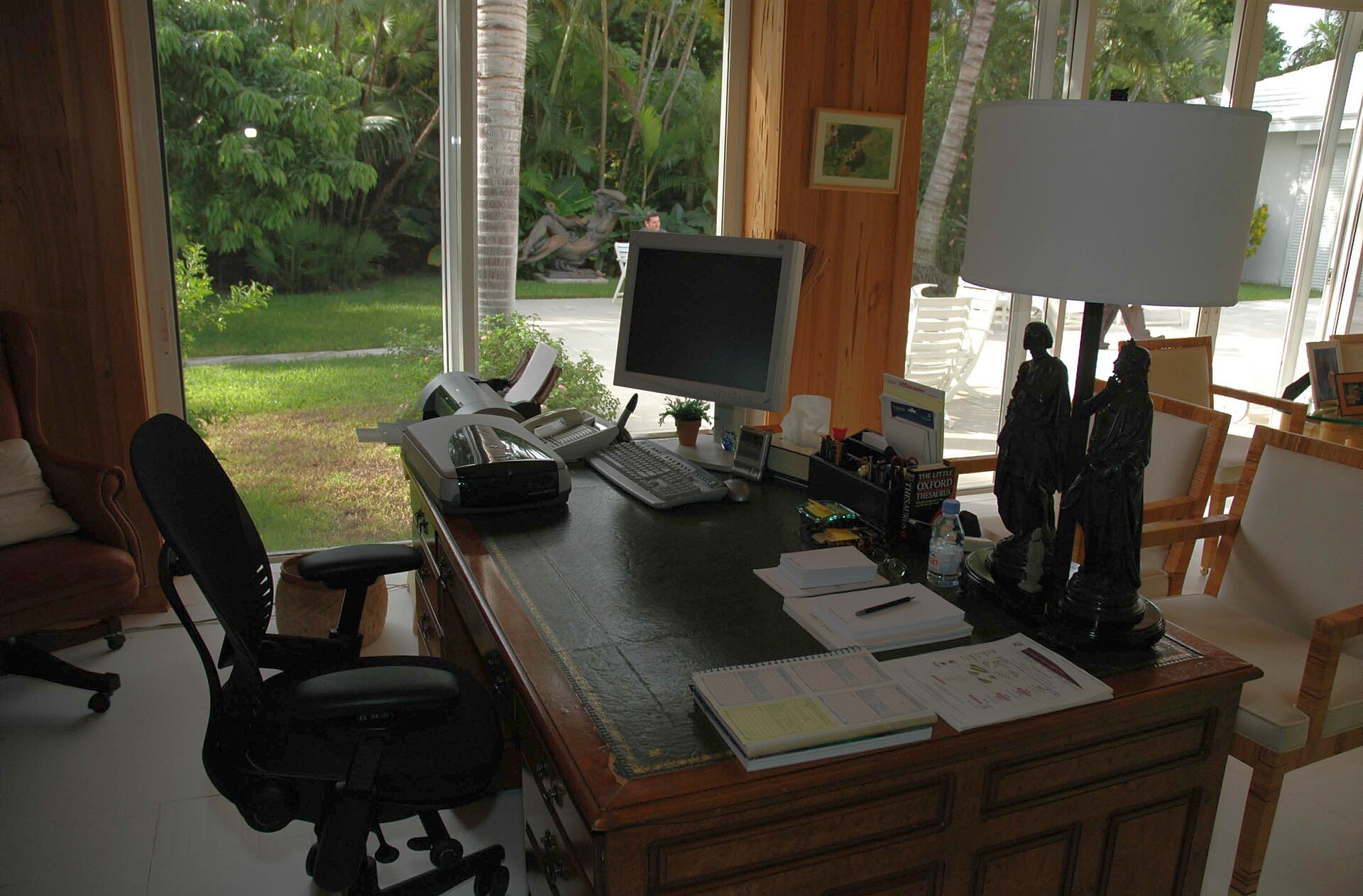 Home office desk setup with monitor, keyboard and an adjustable ergonomic chair
