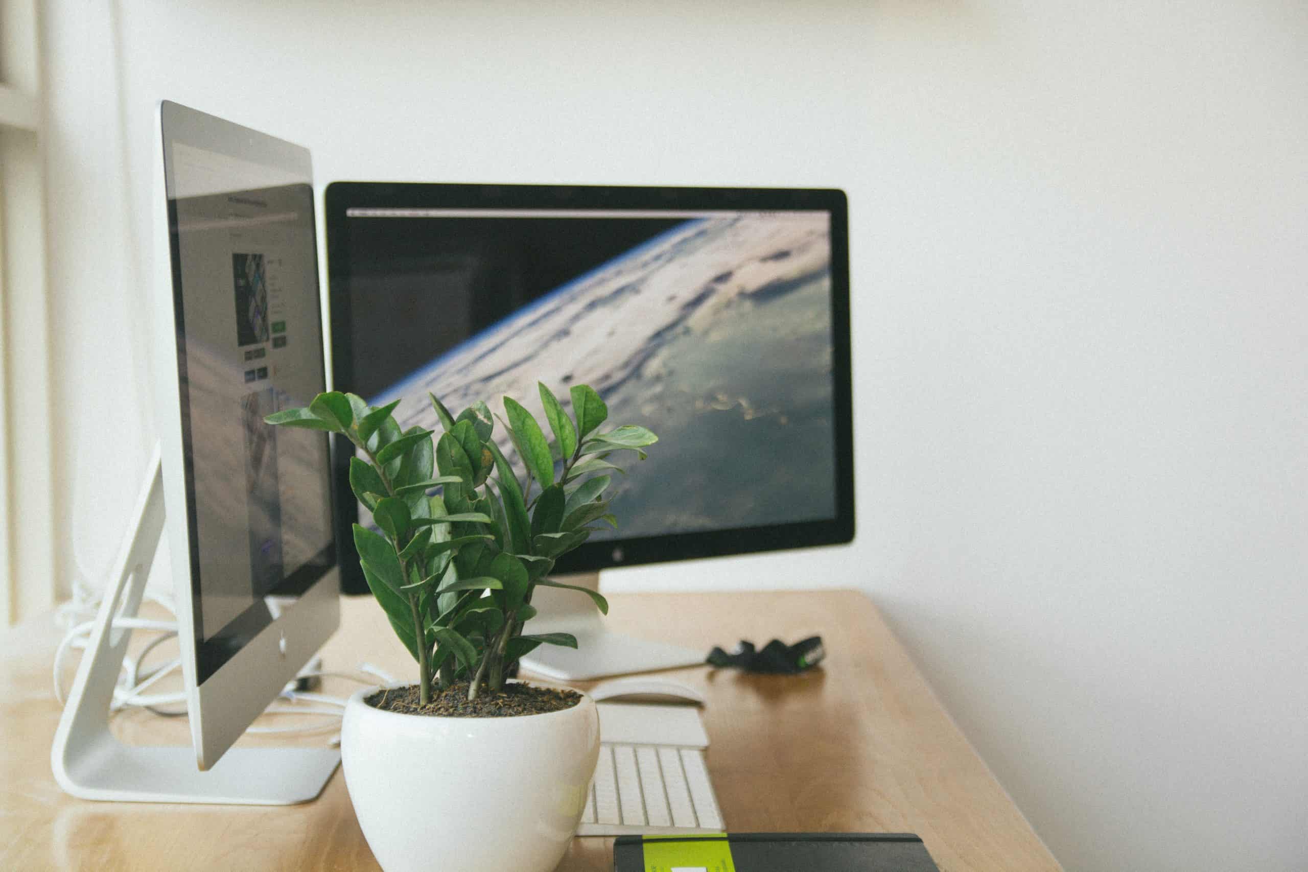 Two computer monitors on a home office desk