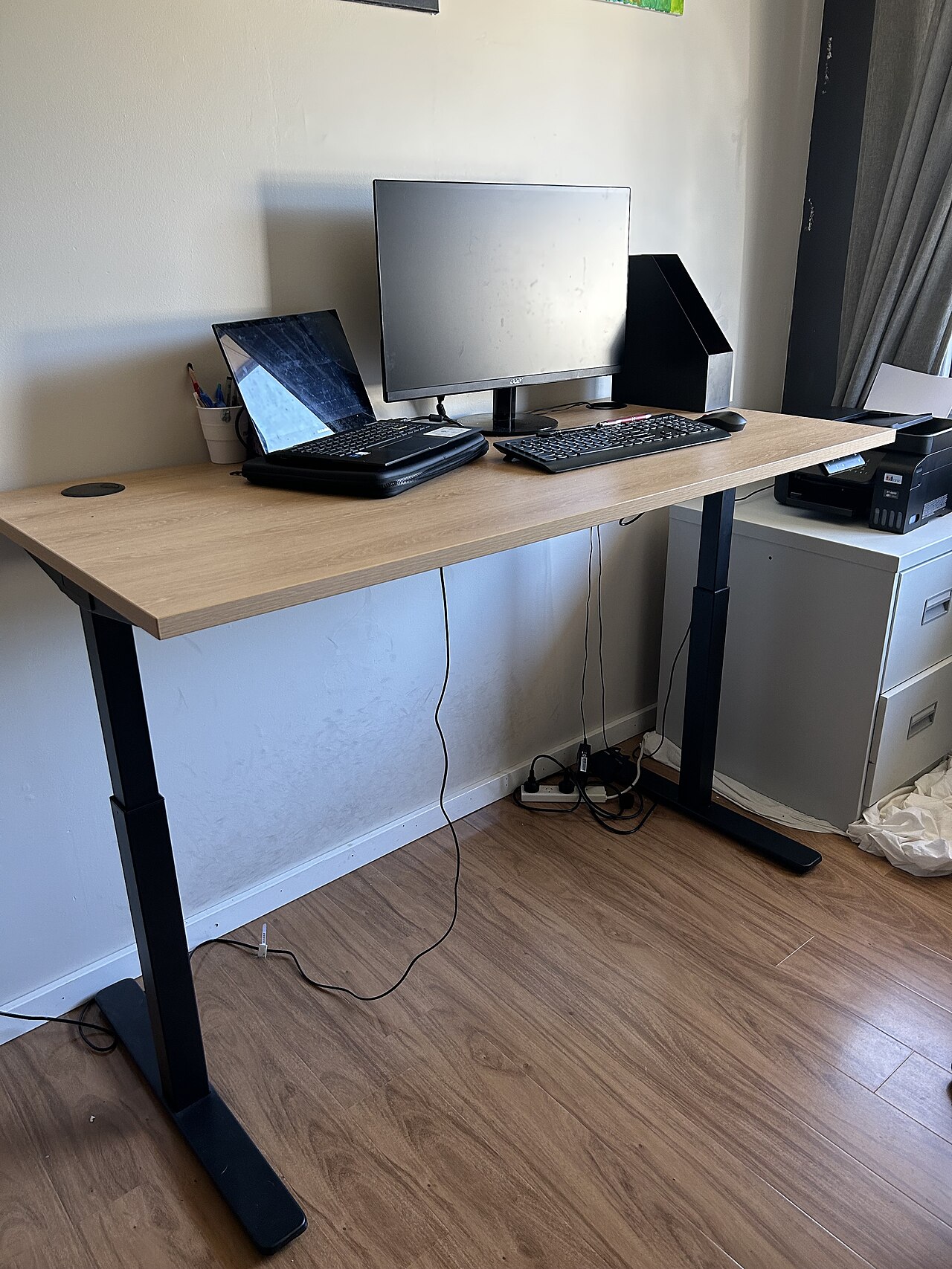 Height-adjustable standing desk workstation at full standing height
