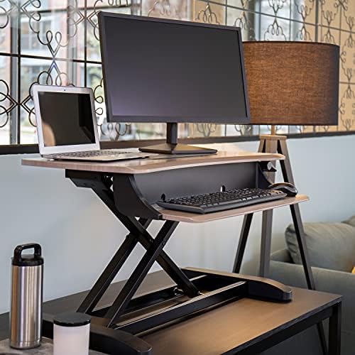 Ergotron WorkFit-Z Mini grey woodgrain desk converter with monitor and laptop