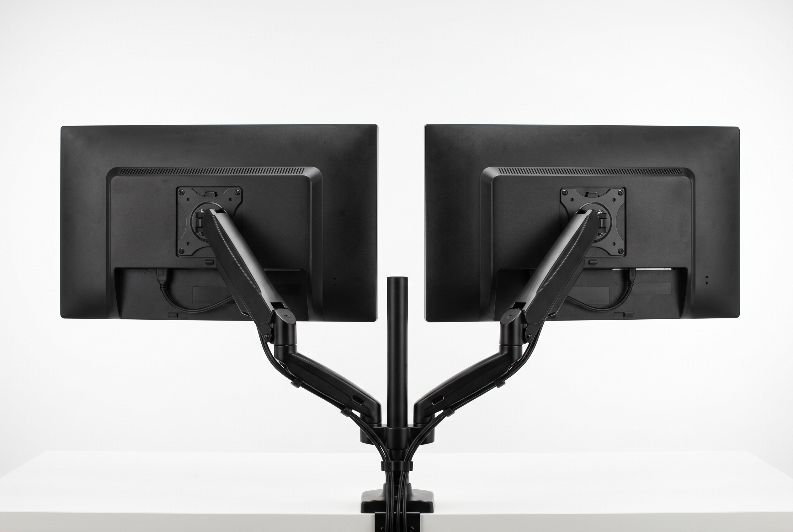 Dual monitor arm with two displays on a compact desk