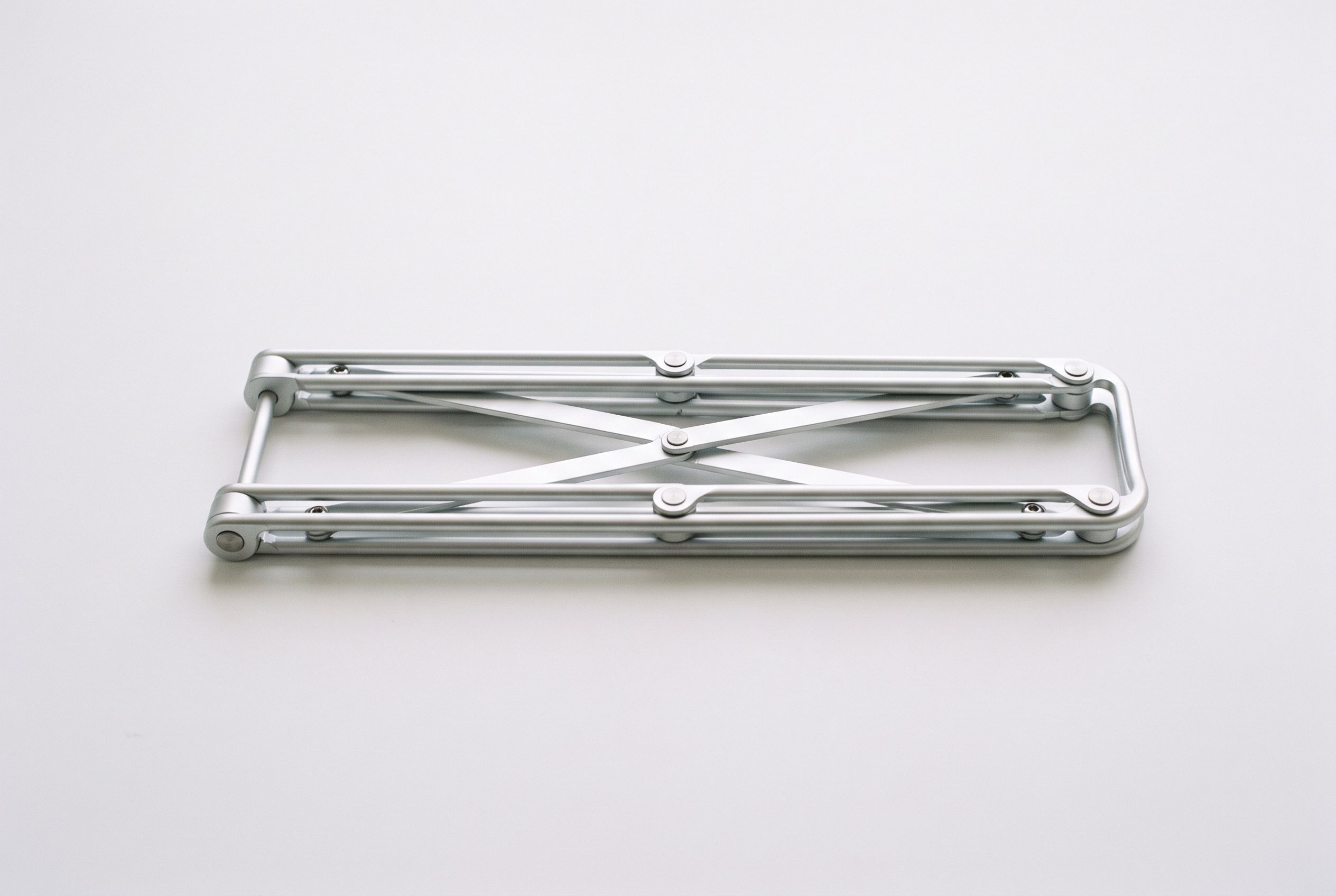 Collapsible aluminum laptop stand folded flat