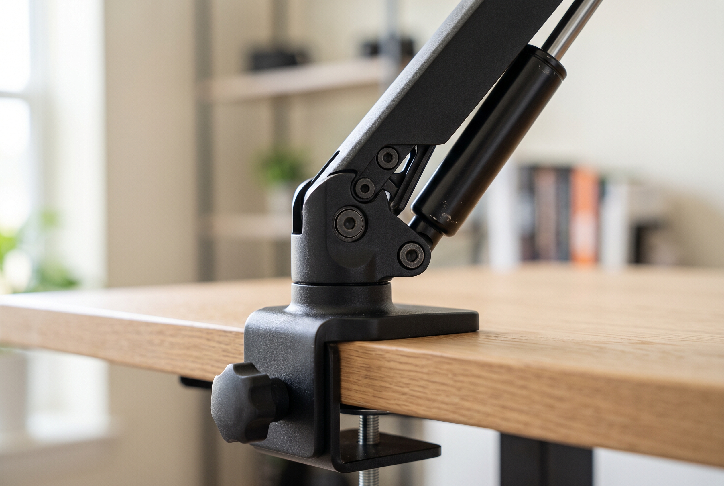Close-up of a gas-spring monitor arm joint and clamp